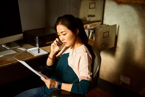 Woman on the telephone looking into options for dealing with unexpected expenses.